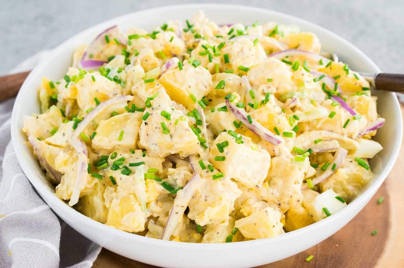 classic potato salad in a white bowl