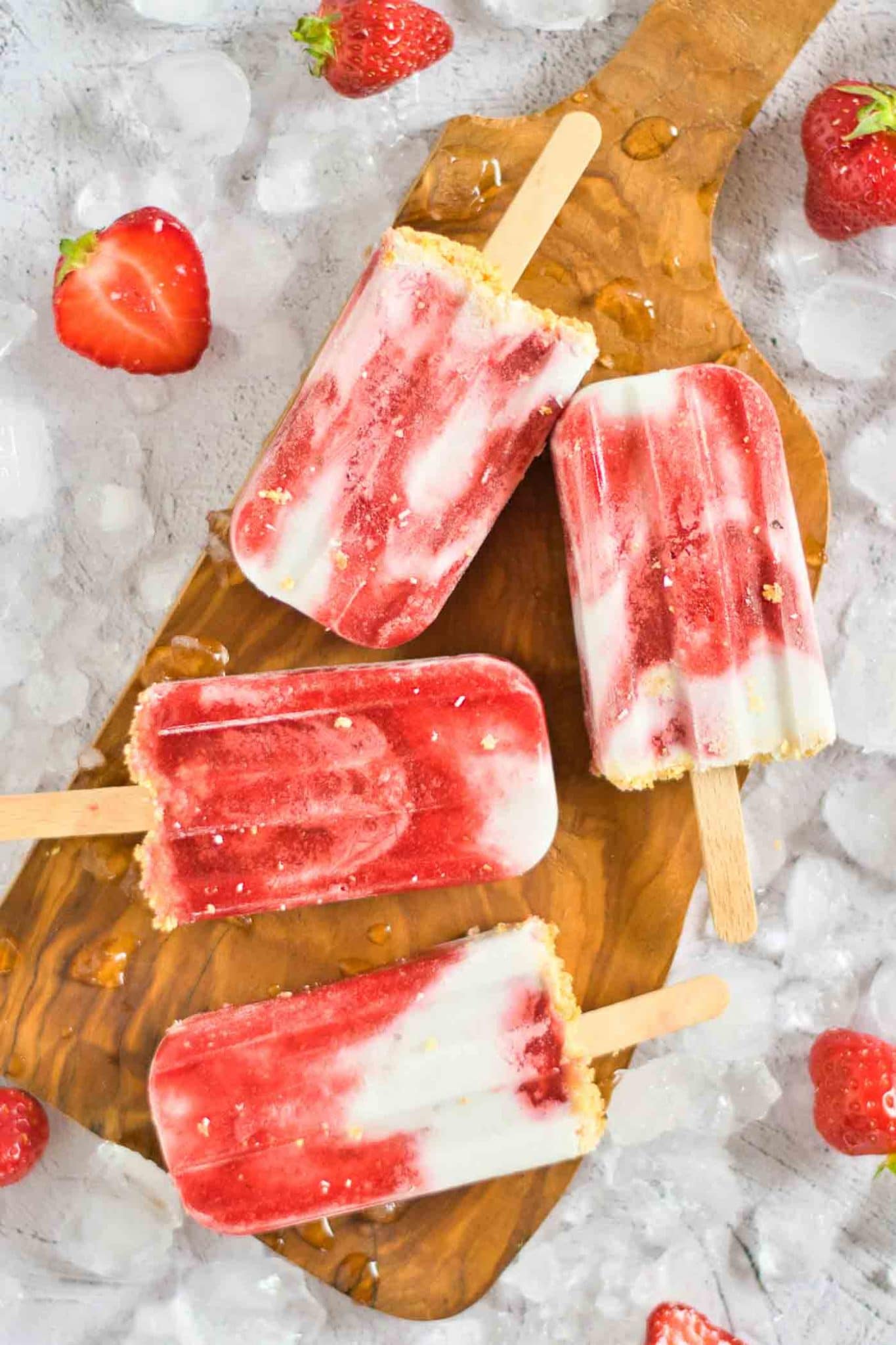 close up of cream popsicles on ice cubes