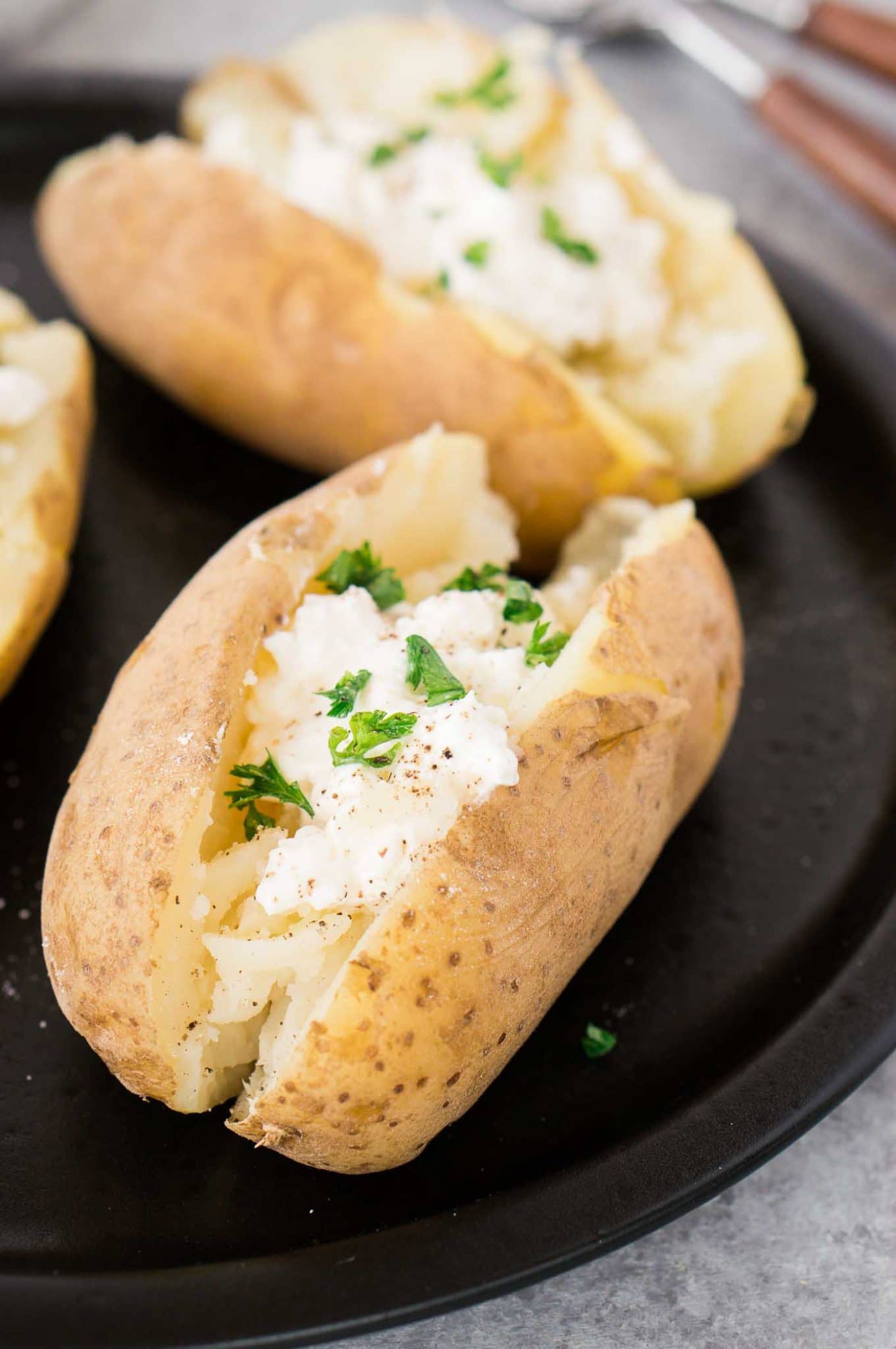 baked potatoes with sour cream  on a plate