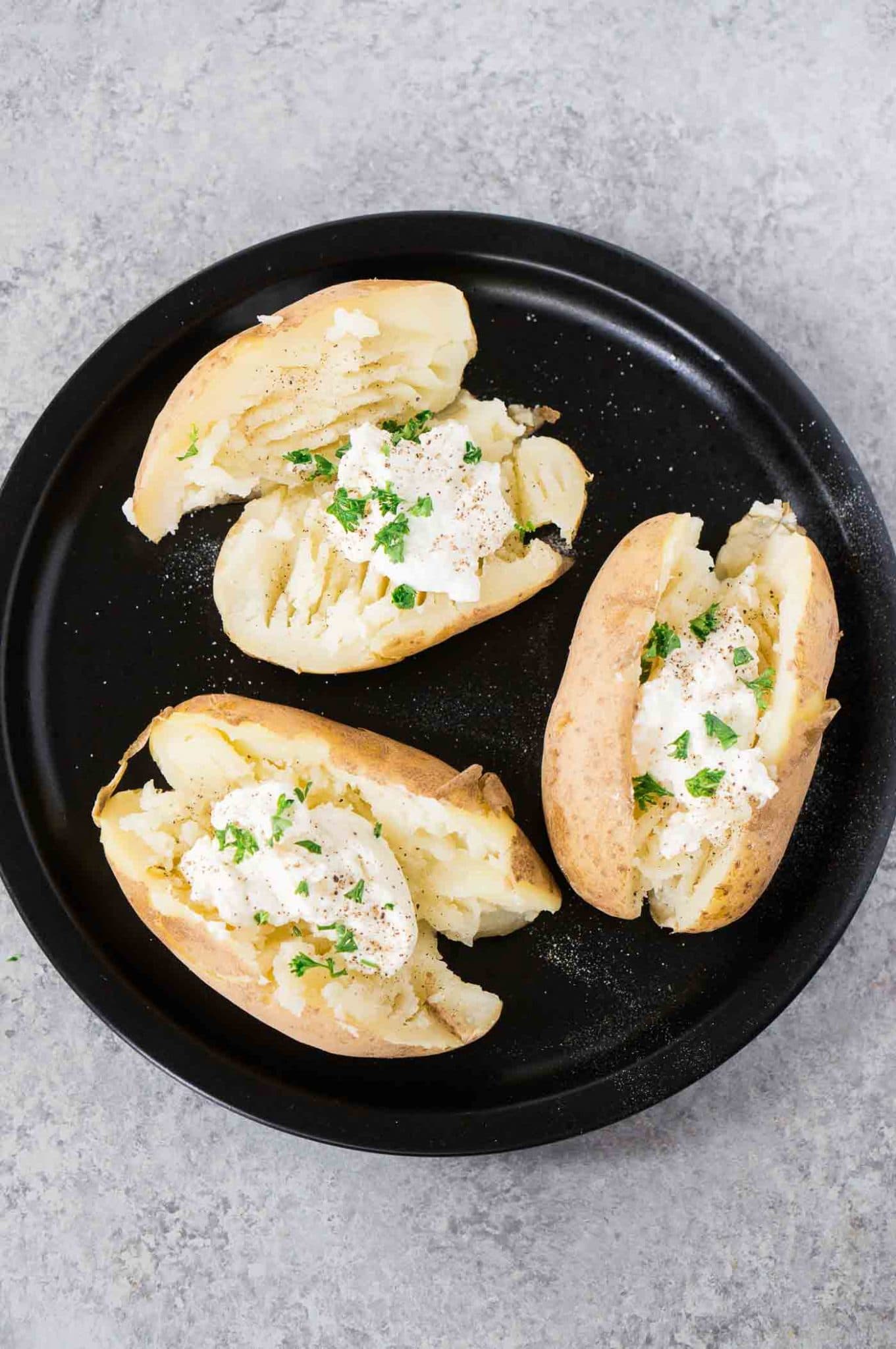 cut baked potatoes on a plate