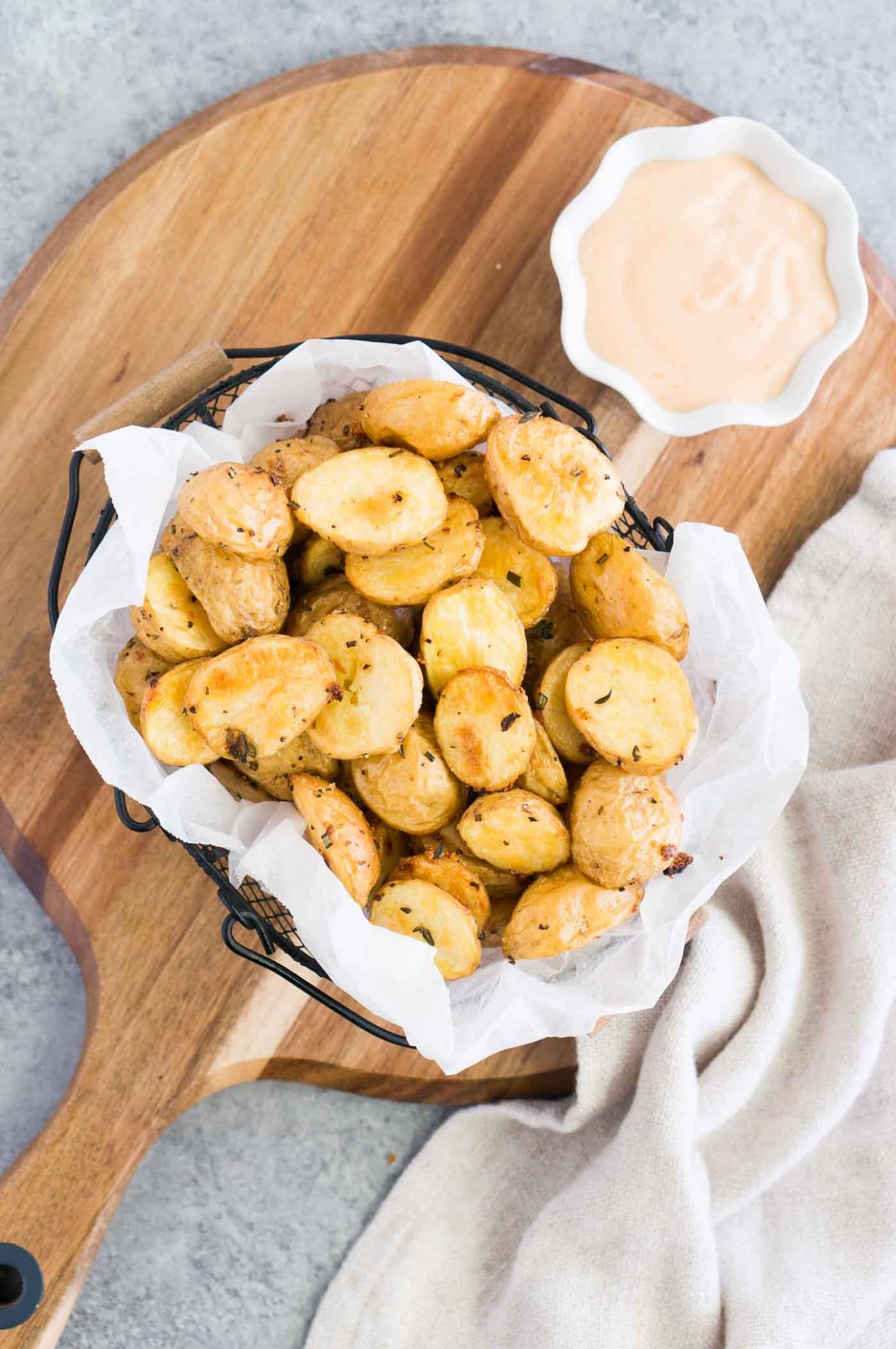 baby potatoes and dipping sauce on a board