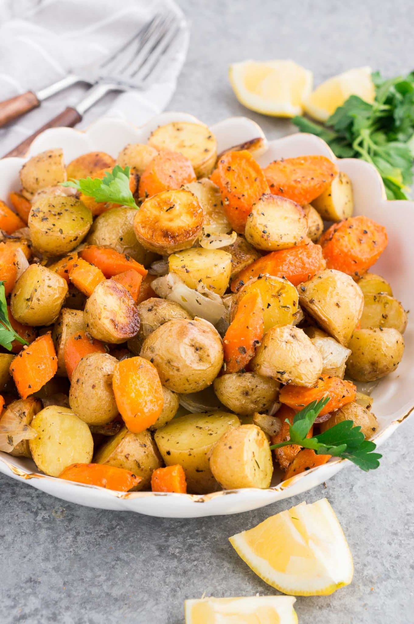 roasted potatoes and carrots and caramelized onions in a serving bowl