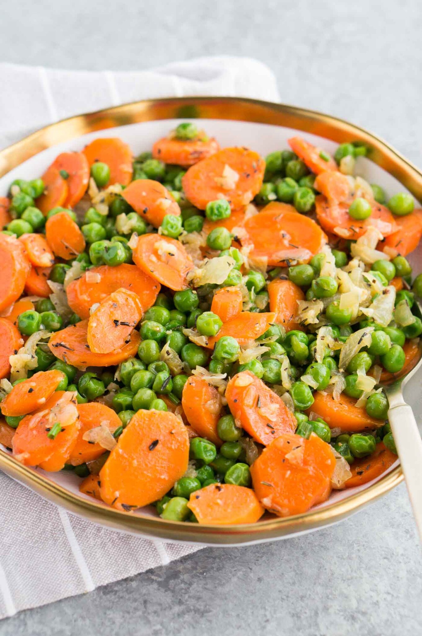quick and east peas and carrots recipe served in a bowl