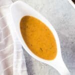close up image of homemade gravy in a gravy boat