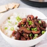 red beans and rice with sausage served over rice in a bowl
