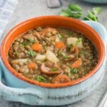 close up image of lentil soup with sausage in a bowl