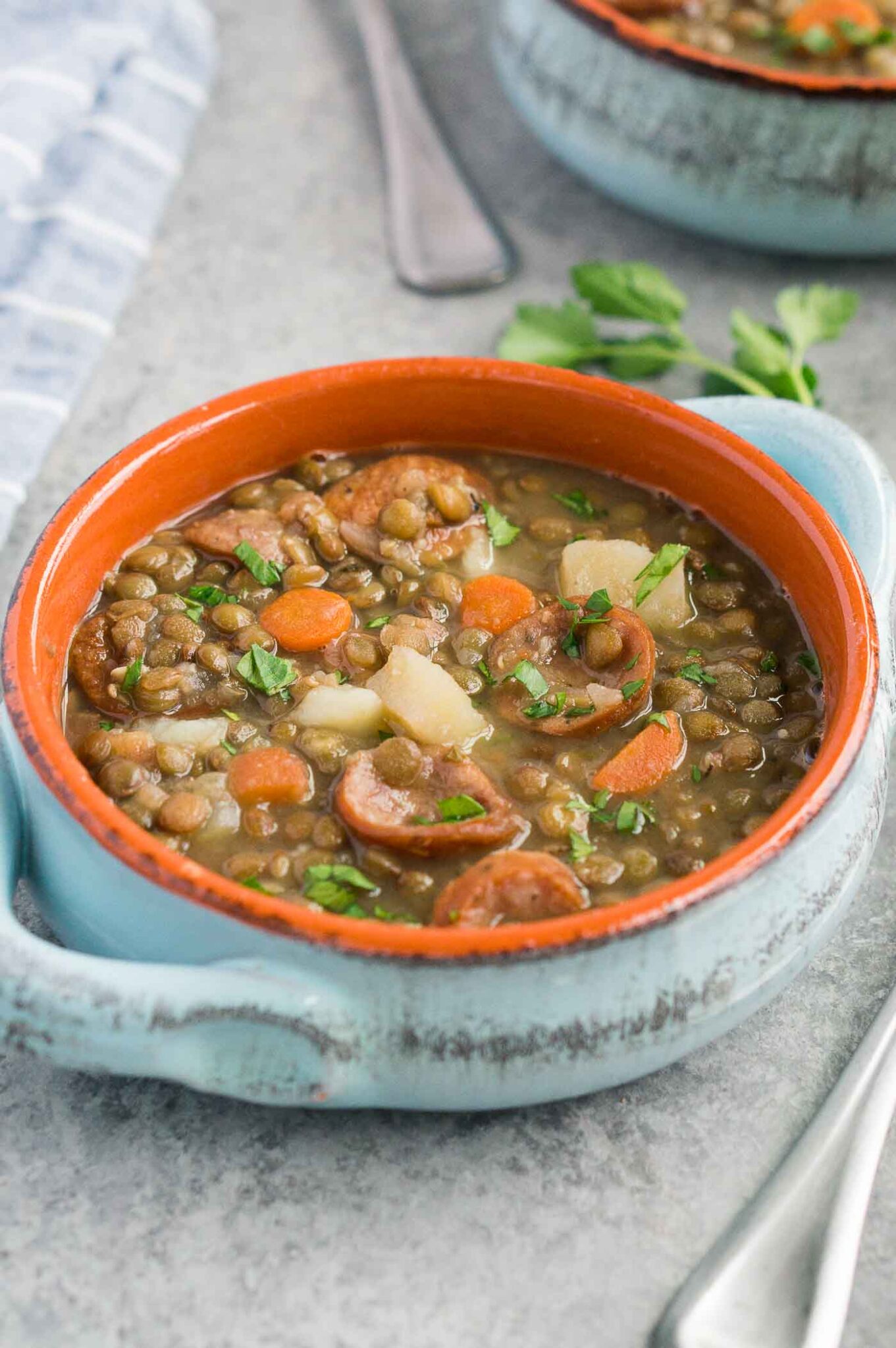 close up image of lentil soup with sausage in a bowl