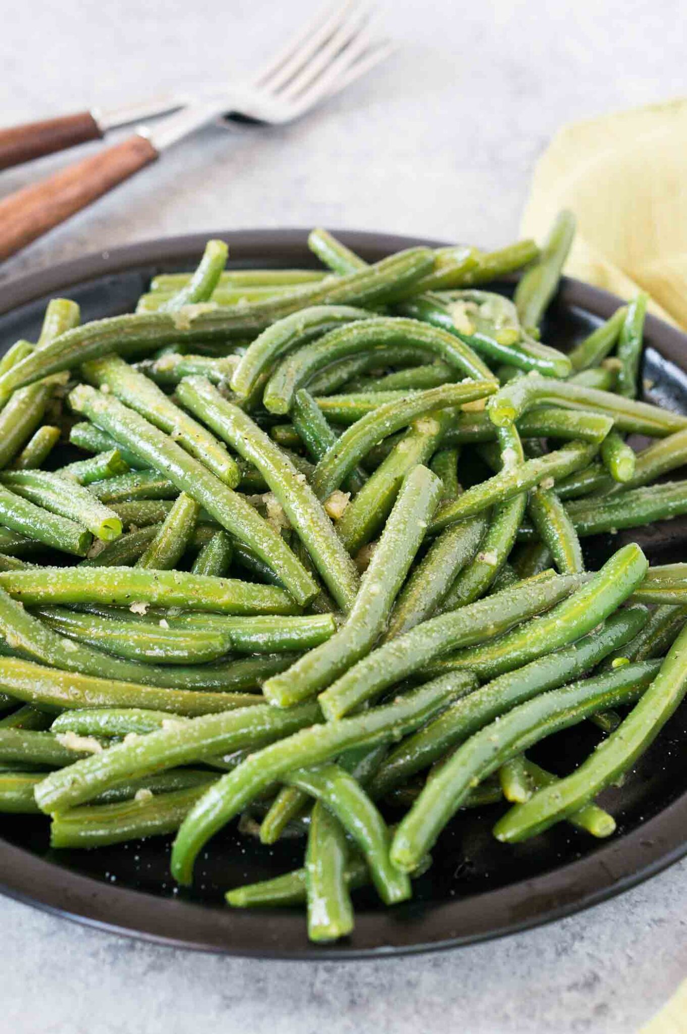 seasoned pressure cooked green beans on a black plate