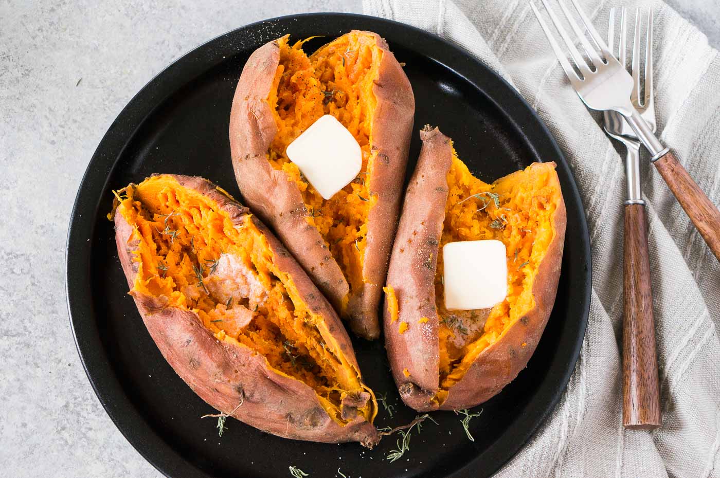 baked sweet potatoes with butter on a plate