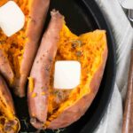 close up image of sweet potatoes cut in half on a plate