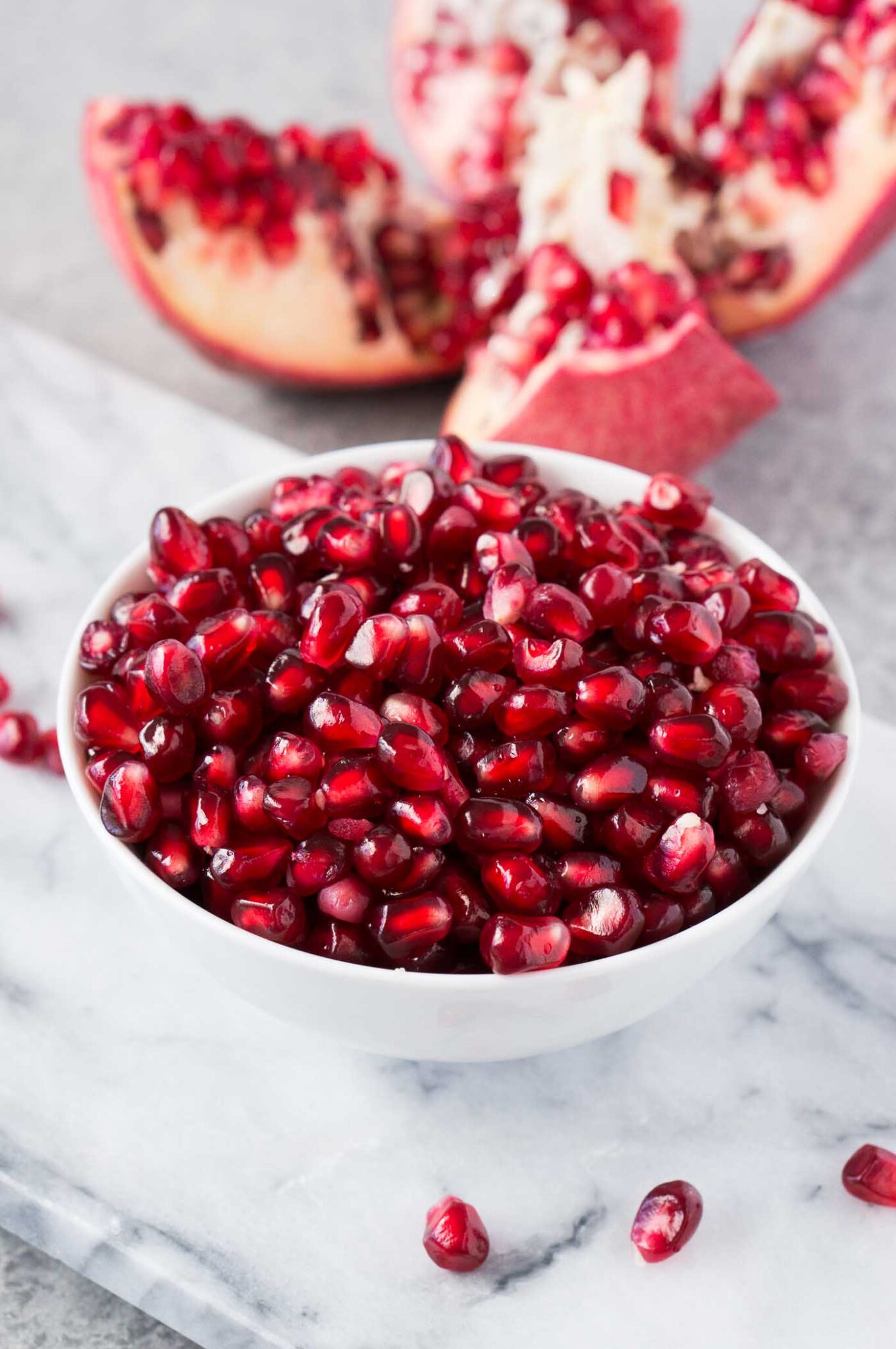 pomegranate seeds in a white bowl
