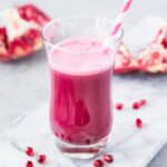 pomegranate juice in a glass with straw
