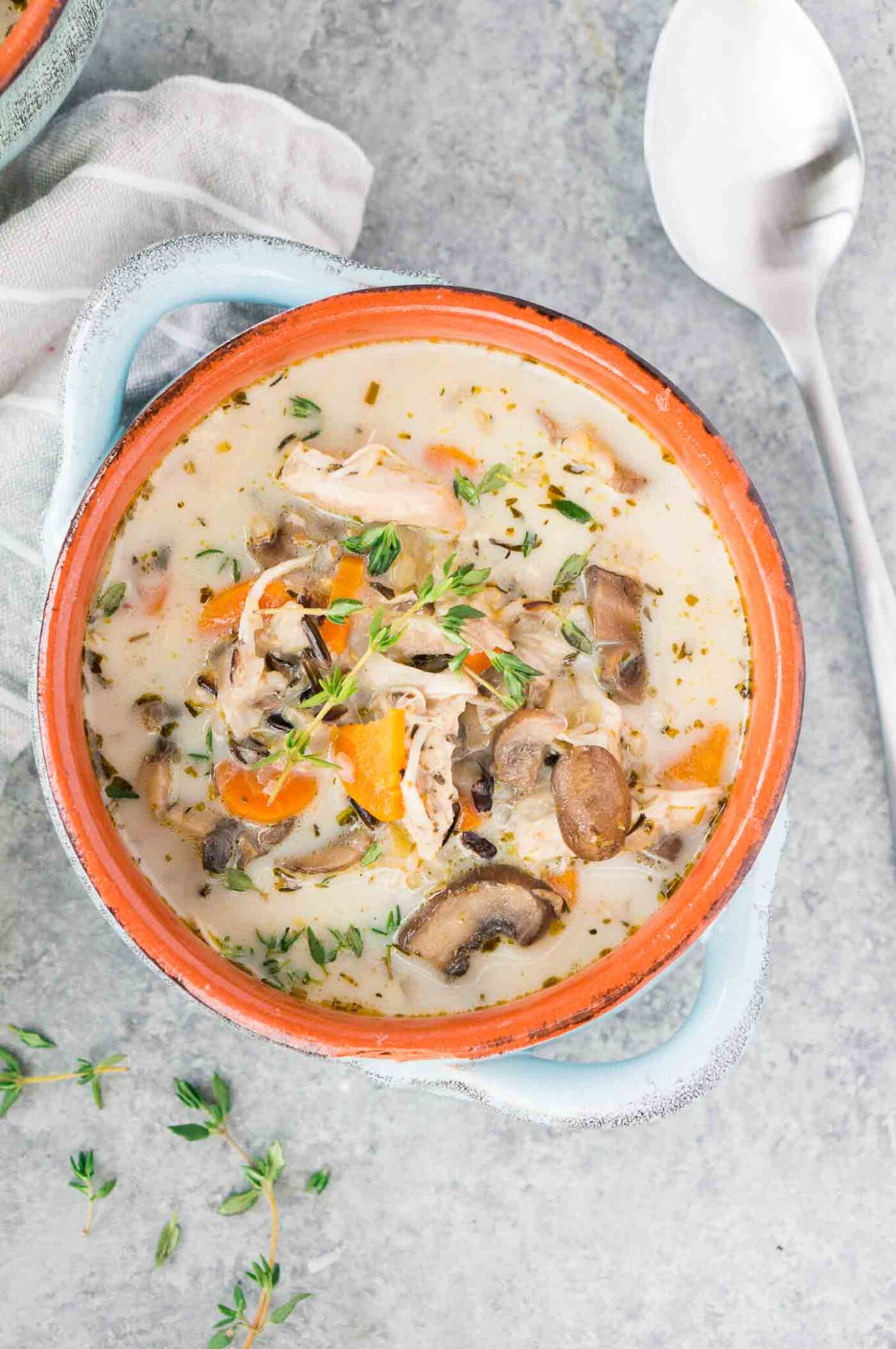 creamy chicken mushroom wild rice soup in a clay bowl
