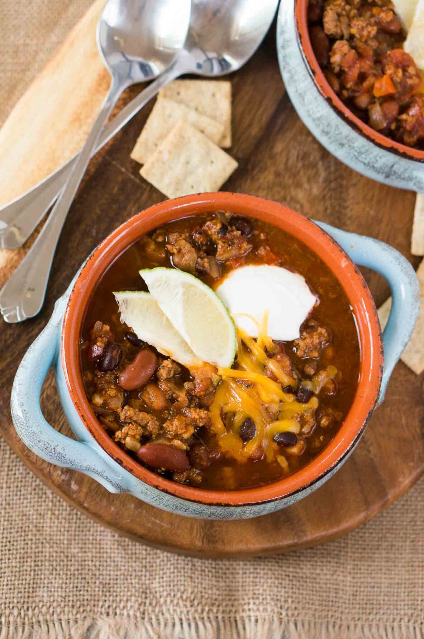 close up image of instant pot chili in a bowl with toppings
