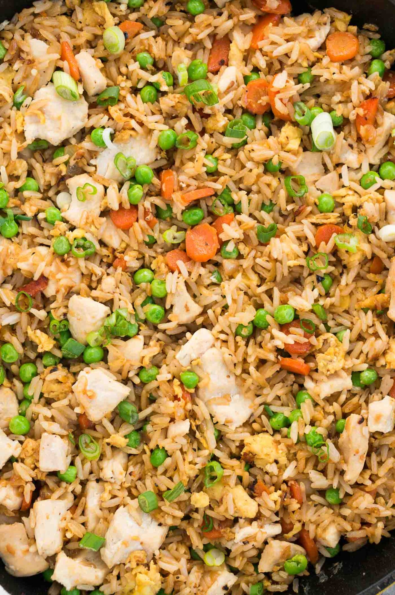 close up of fried rice and chicken in a skillet