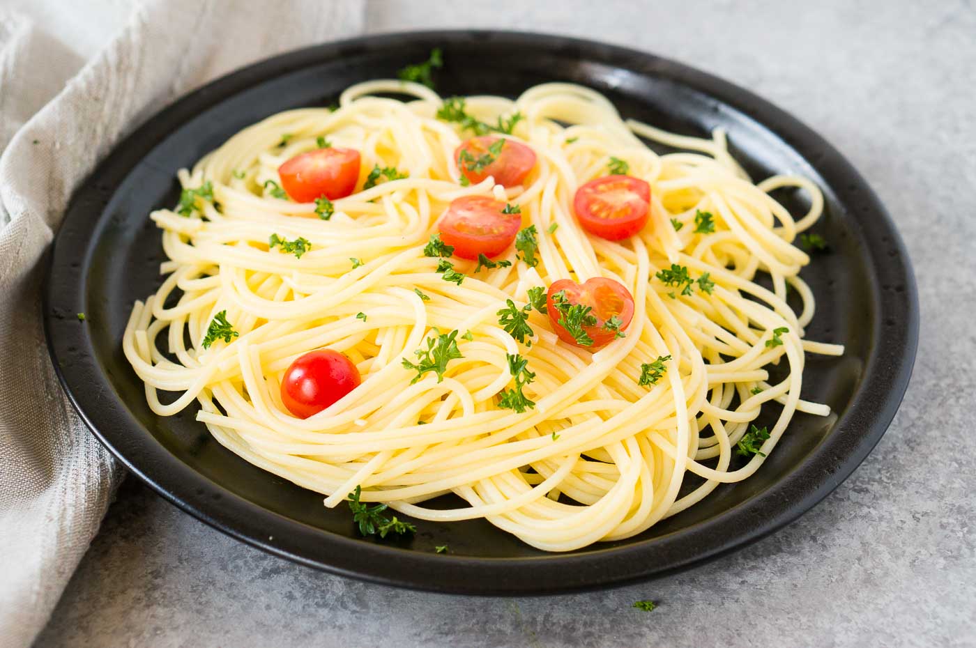 cooked pasta with cherry tomatoes on a plate
