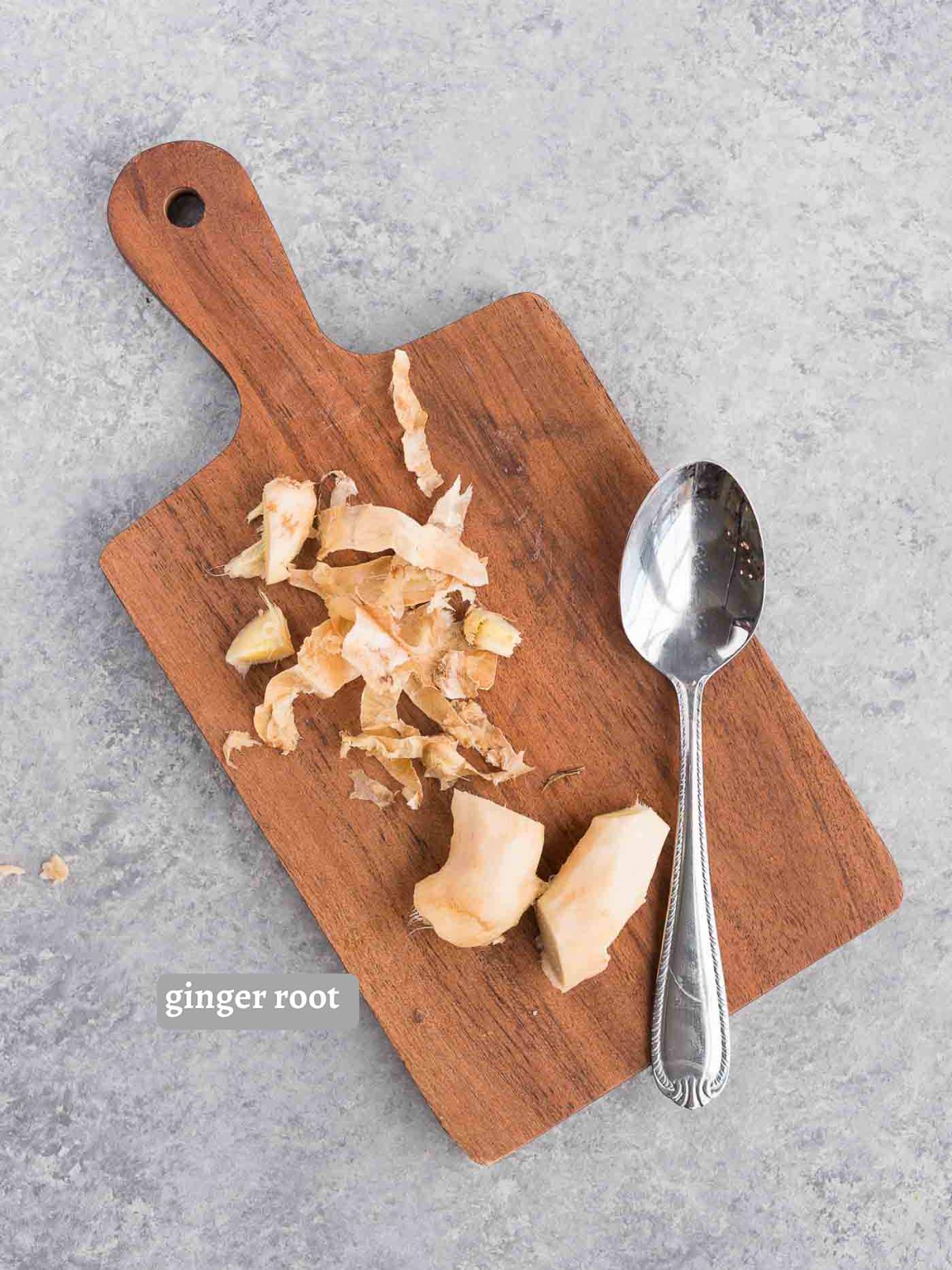 peeled ginger root on a cutting board