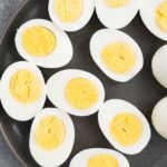 close up image of cut hard boiled eggs on a plate