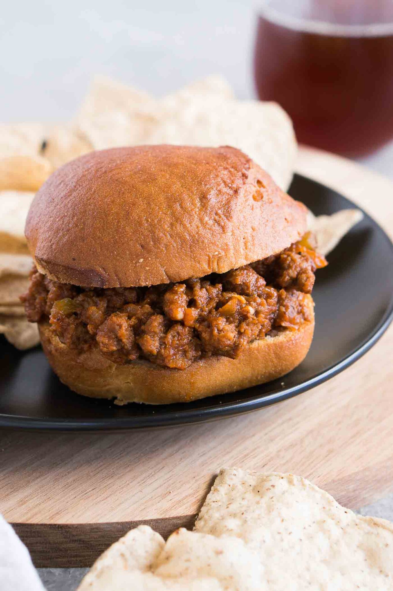 sloppy joes sandwich on a plate with chips