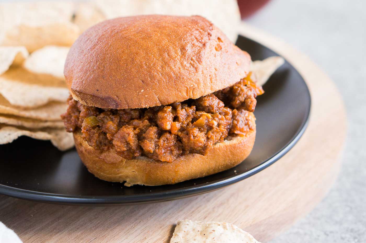close up image of sloppy joes and chips on a plate
