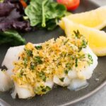baked cod with salad on a plate