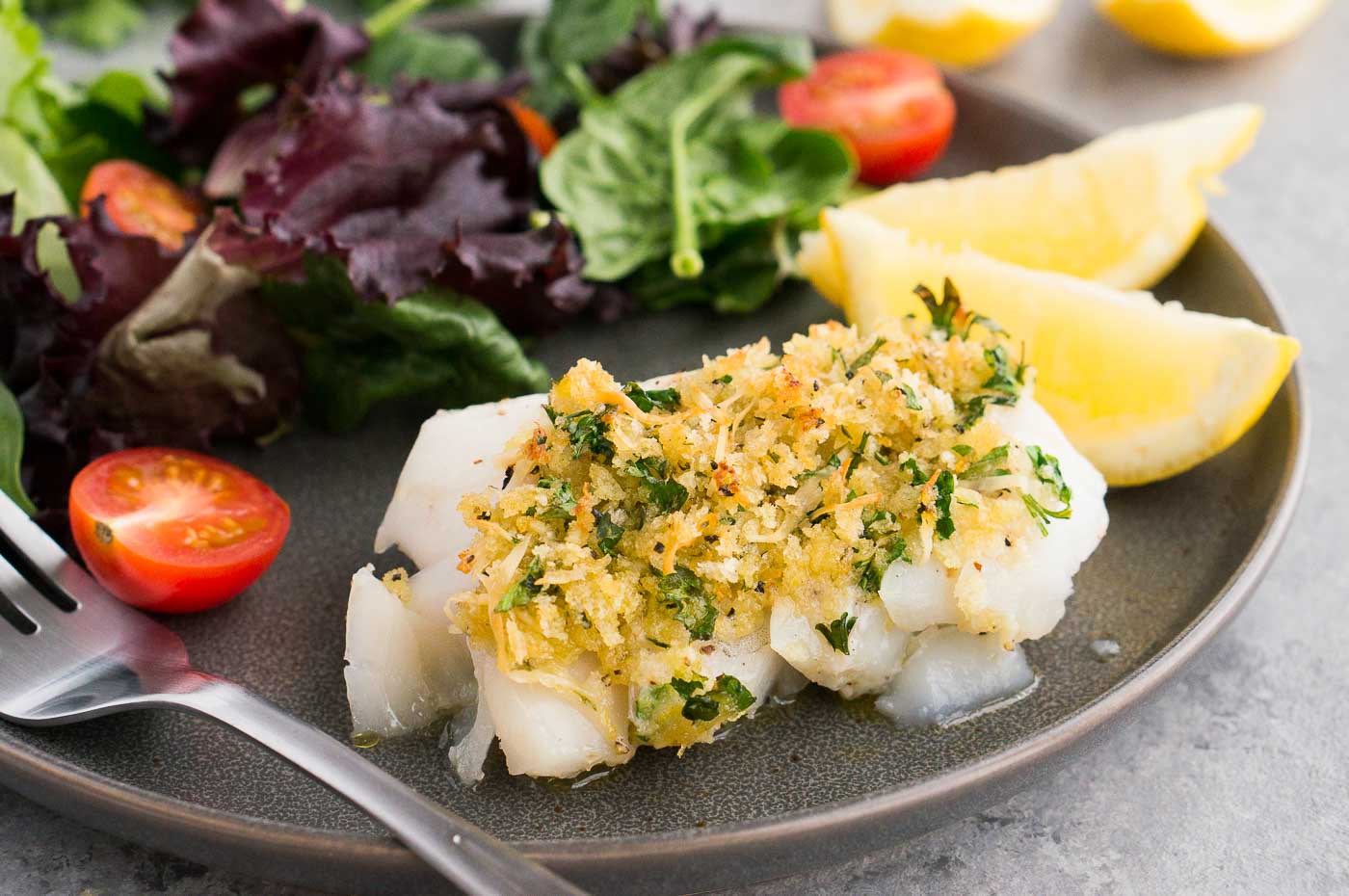 close up image of cod with topping on a plate