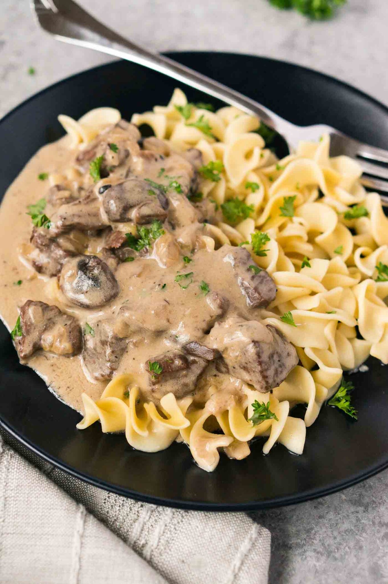 beef stroganoff with mushrooms over noodles