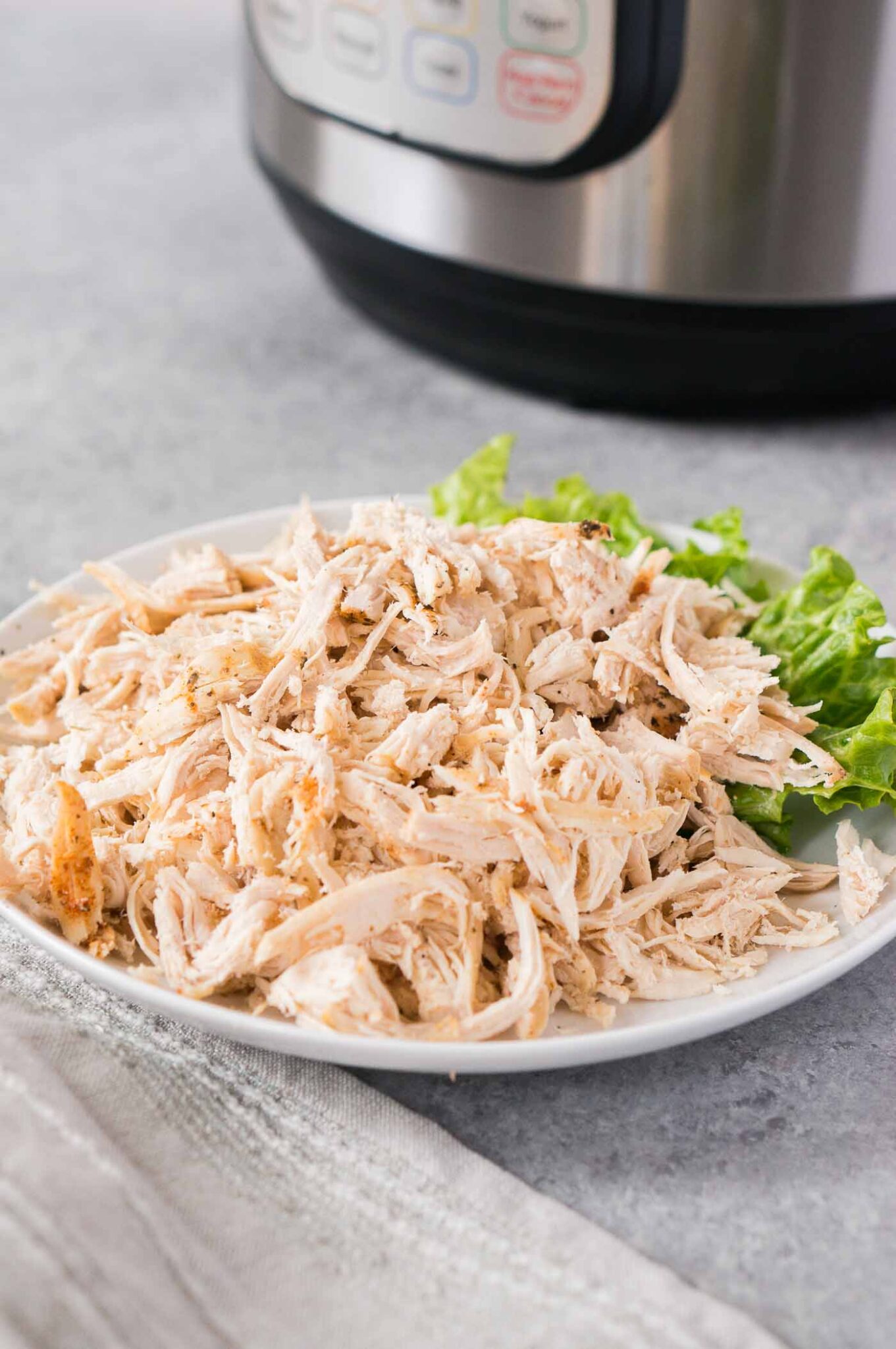 instant pot shredded chicken breasts in a white bowl