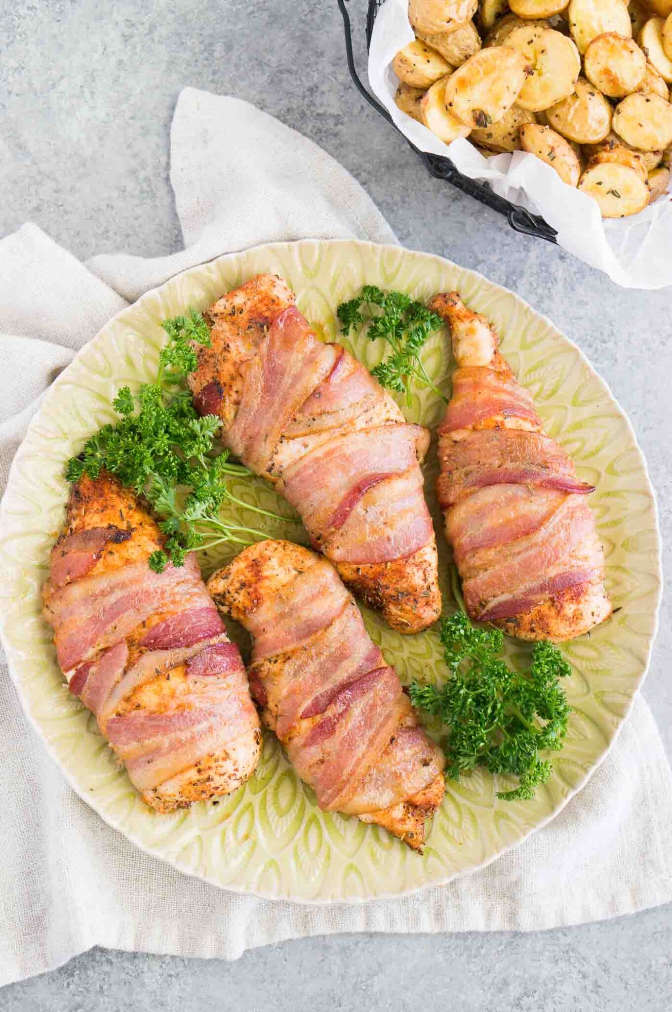 chicken breasts wrapped in bacon on a platter