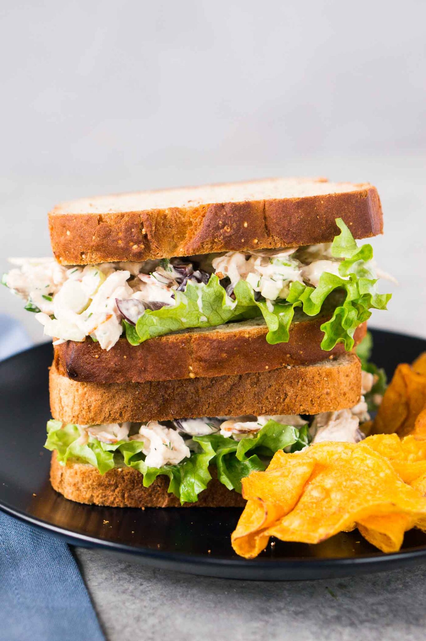 chicken salad sandwiches with chips on a plate