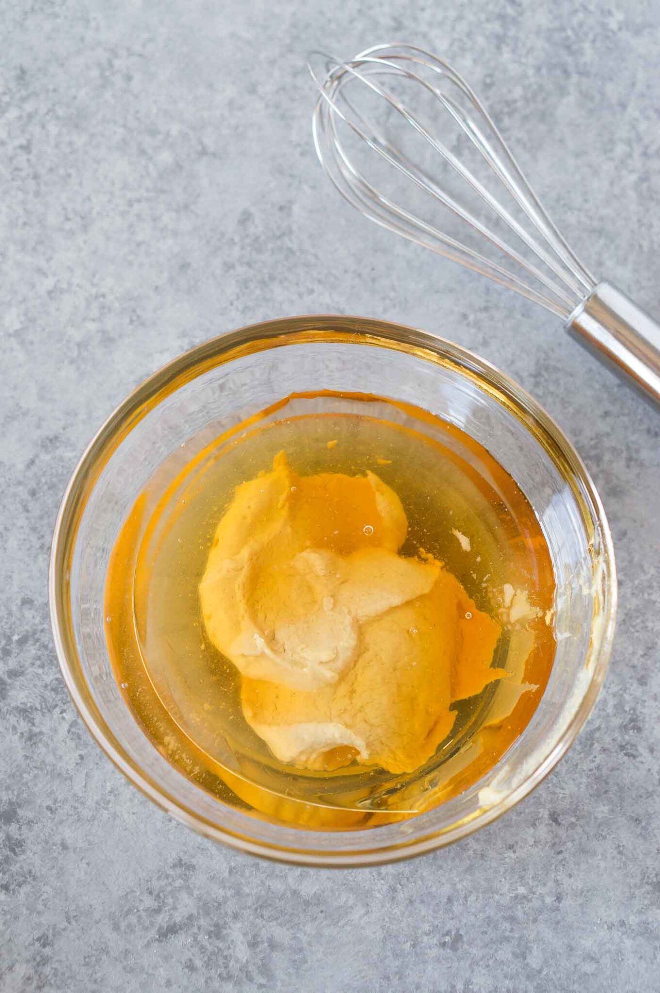 mixing honey dijon vinaigrette in a bowl