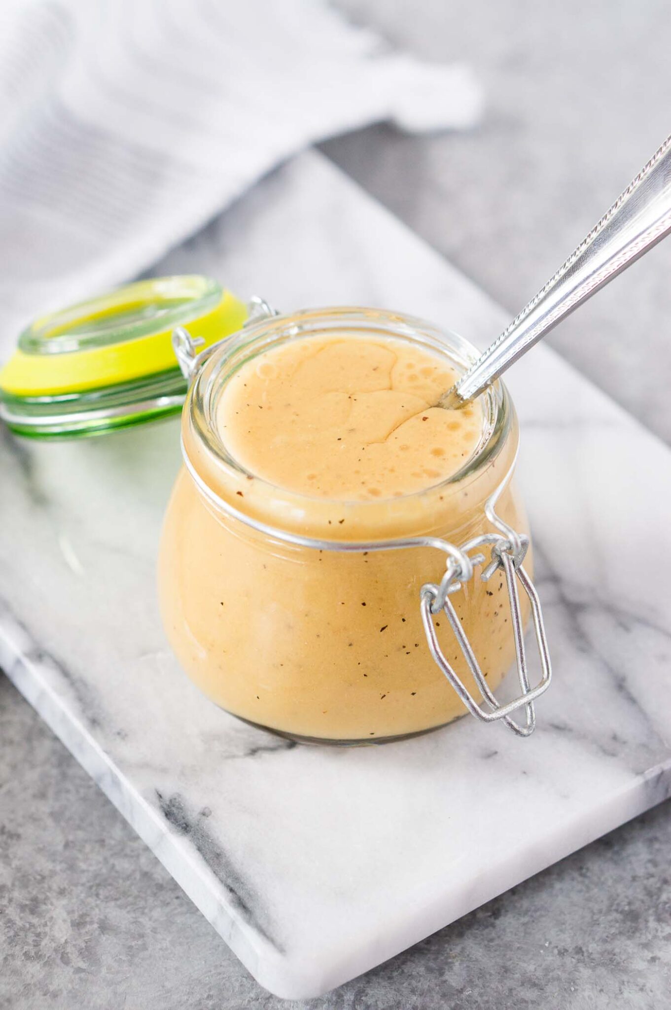 close up image of honey and mustard dressing for salad