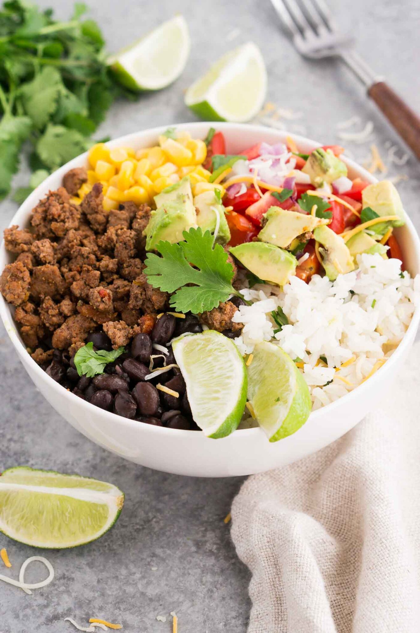 taco meat black beans rice and vegetables in a bowl