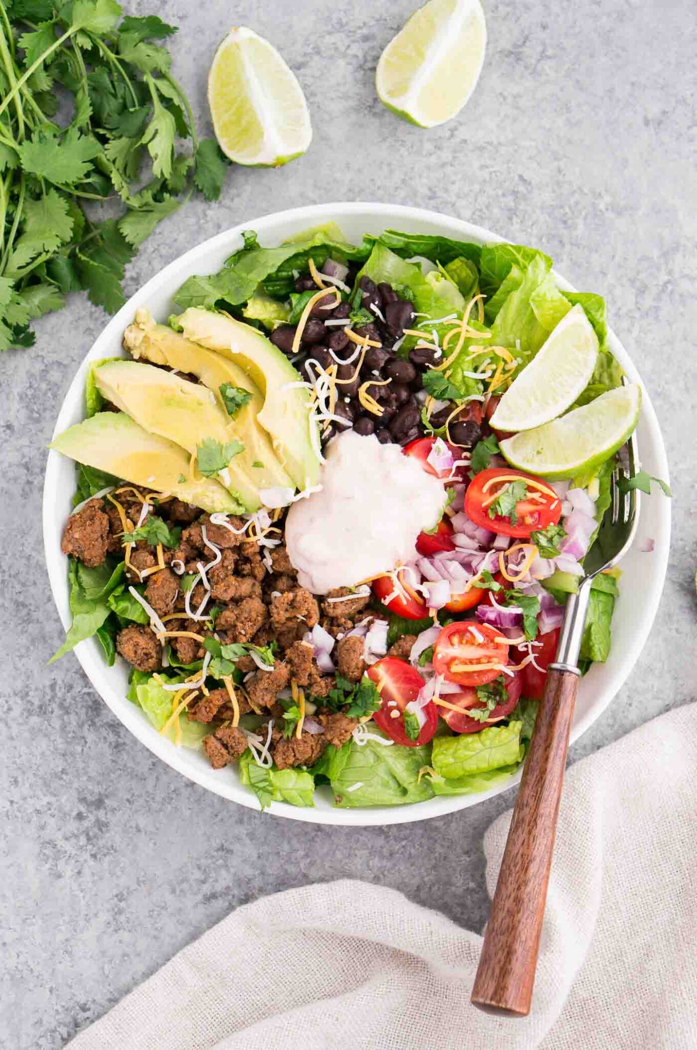 taco salad and dressing in a bowl from above