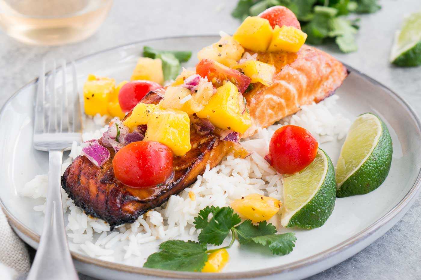 close up image of honey baked salmon with salsa on rice