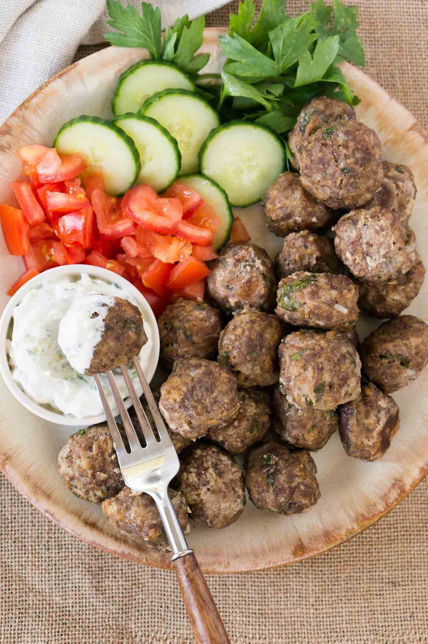 greek meatballs (keftedes) with cucumbers tomatoes and tzatziki sauce