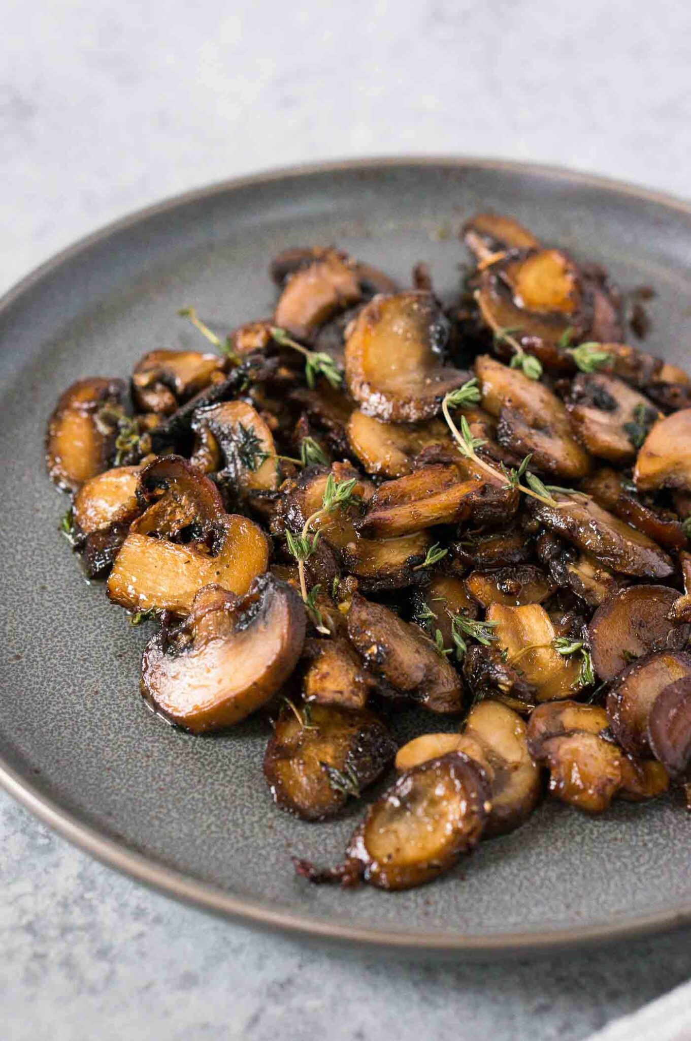 close up image of cooked baby bella mushrooms on a plate