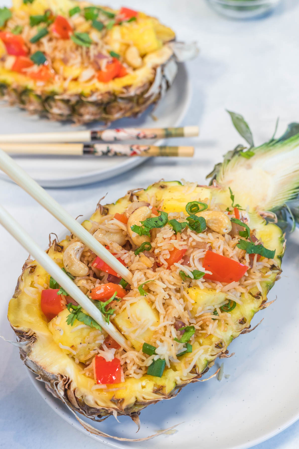 close up image of pineapple fried rice serve in half pineapple