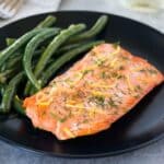 serve sous vide salmon on a plate with green beans