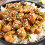 honey garlic chicken over white rice in a bowl