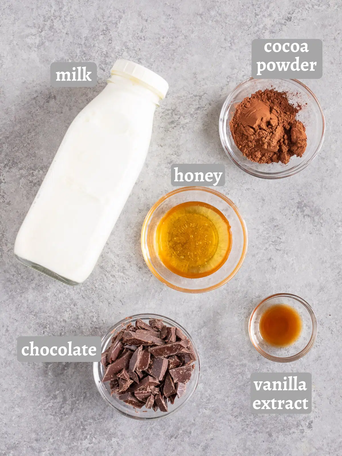 Arrangement of healthy hot chocolate ingredients including milk, cocoa, honey, and chocolate