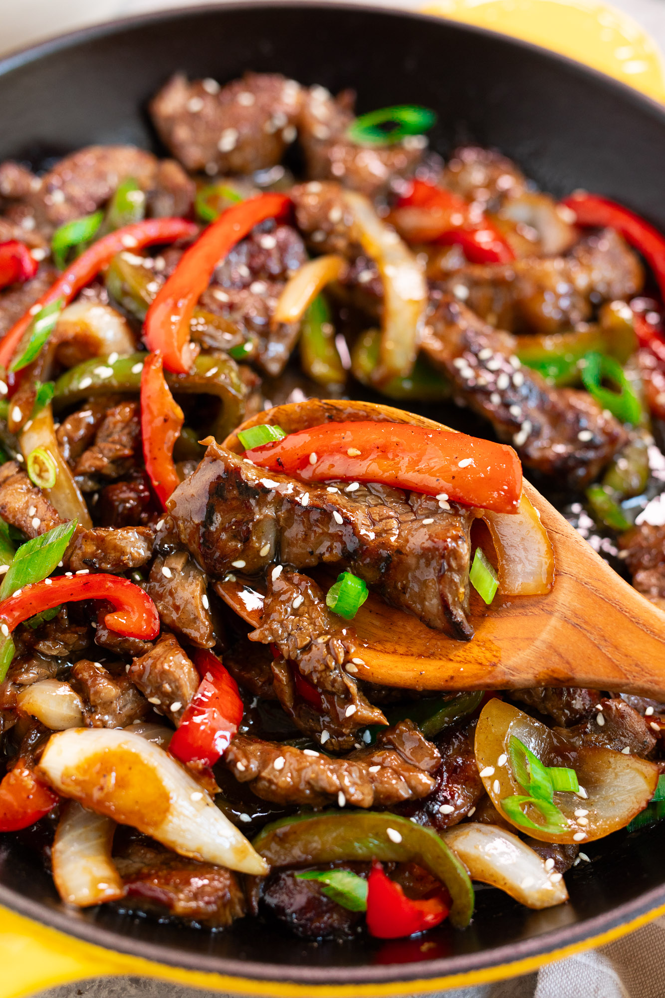 scooping beef and peppers stir fry