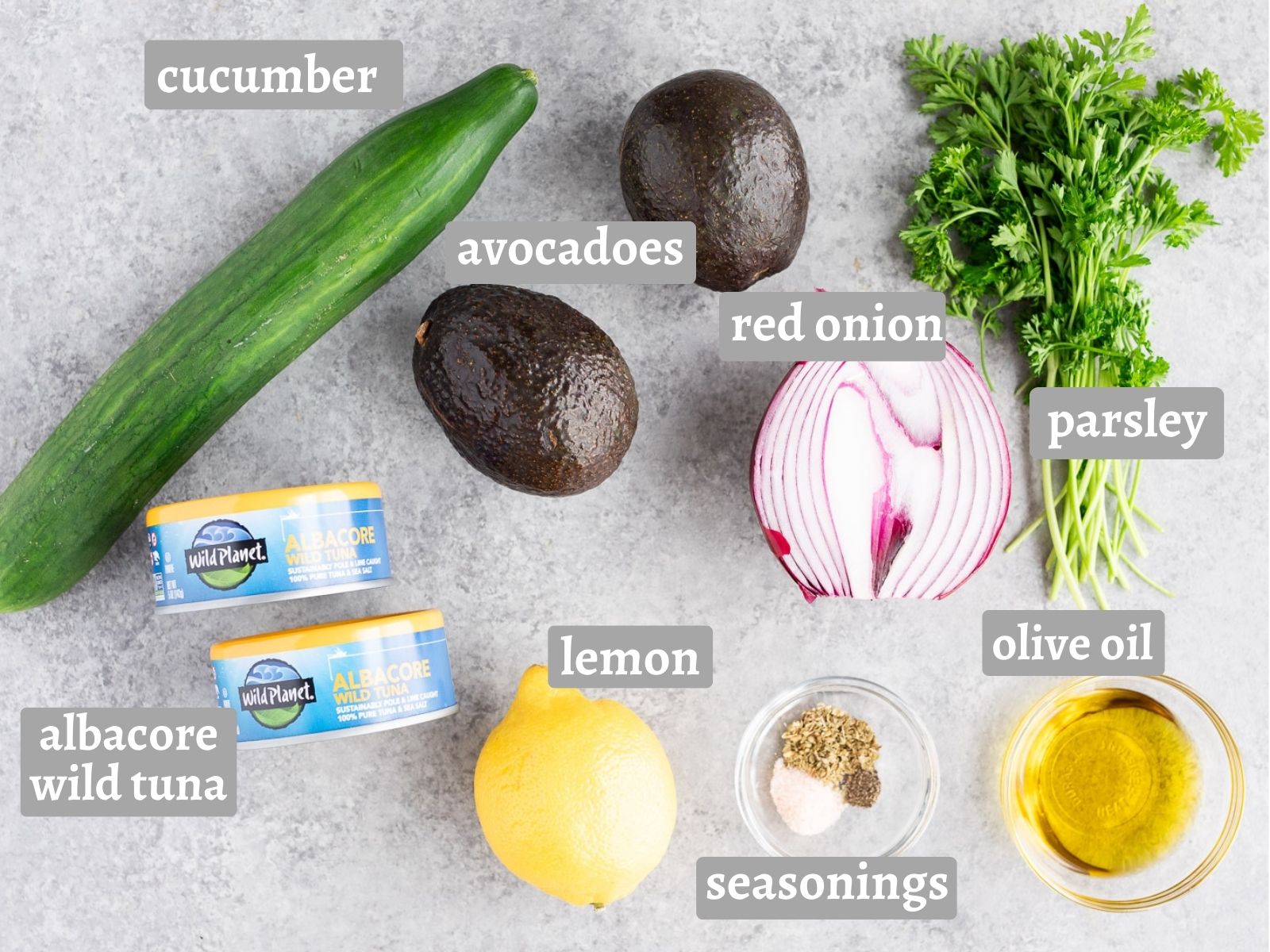 ingredients for salad with avocadoes cucumber and tuna