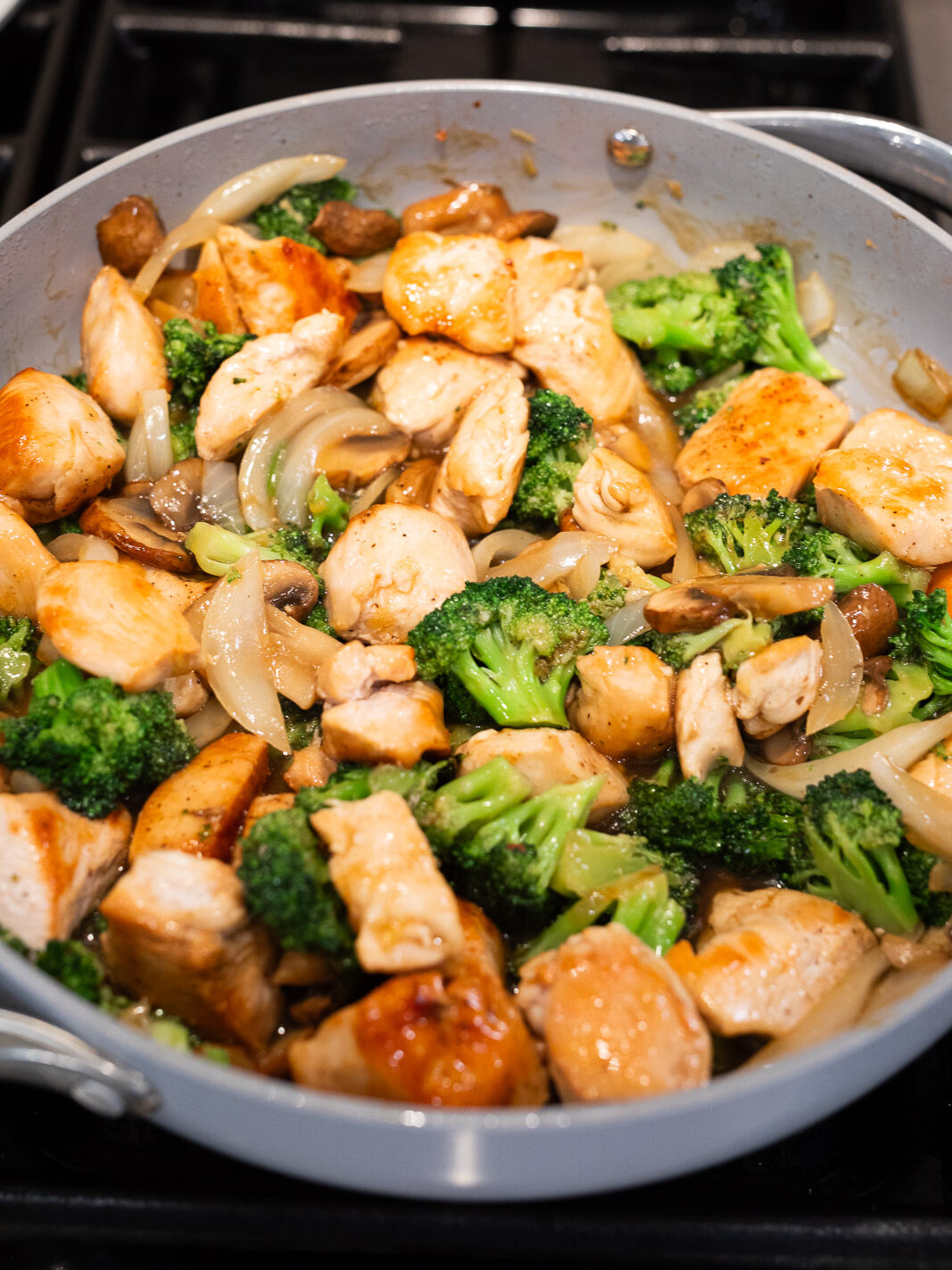 cooking chicken broccoli stir fry in a skillet