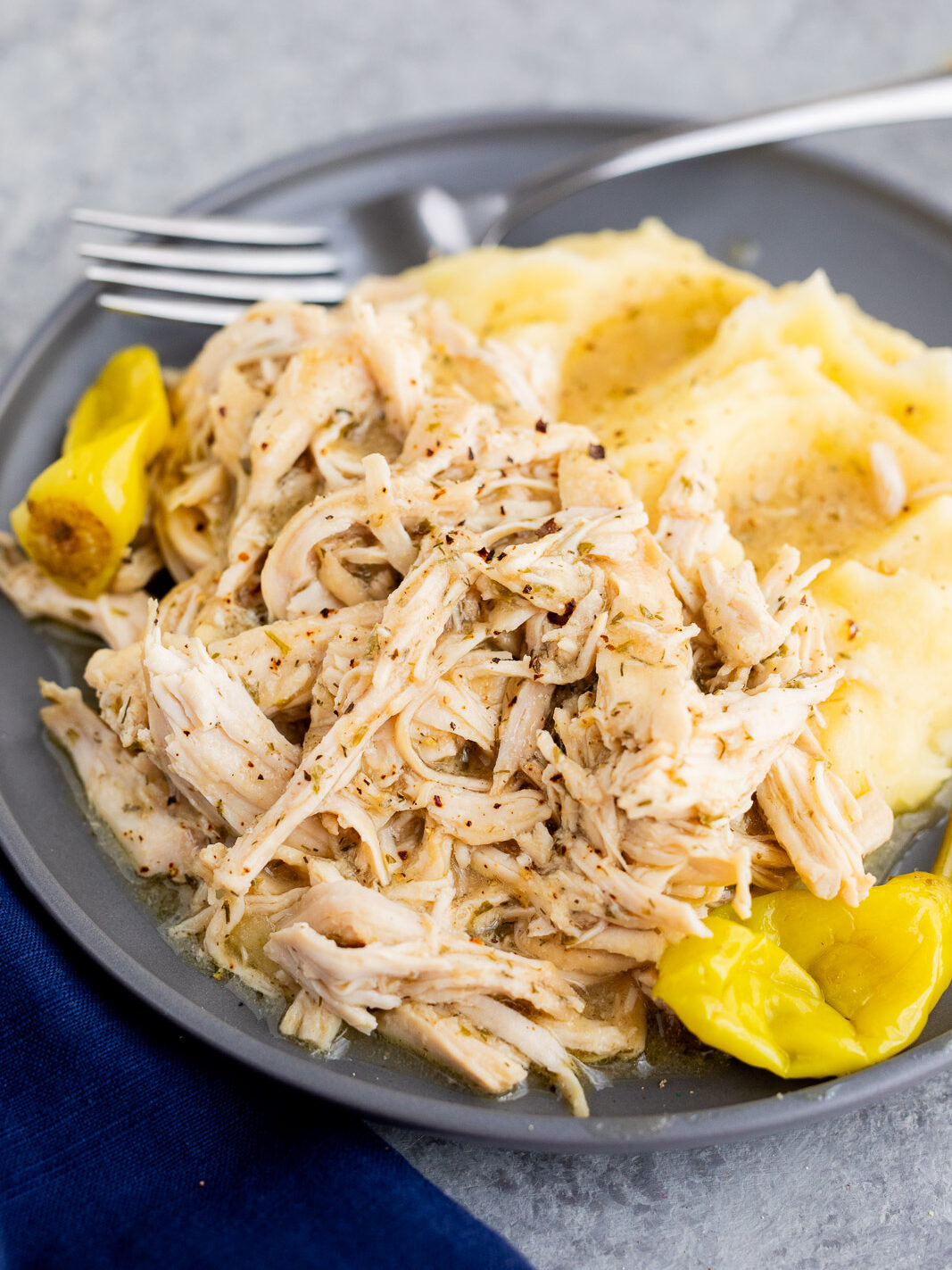 Mississippi chicken served over mashed potatoes