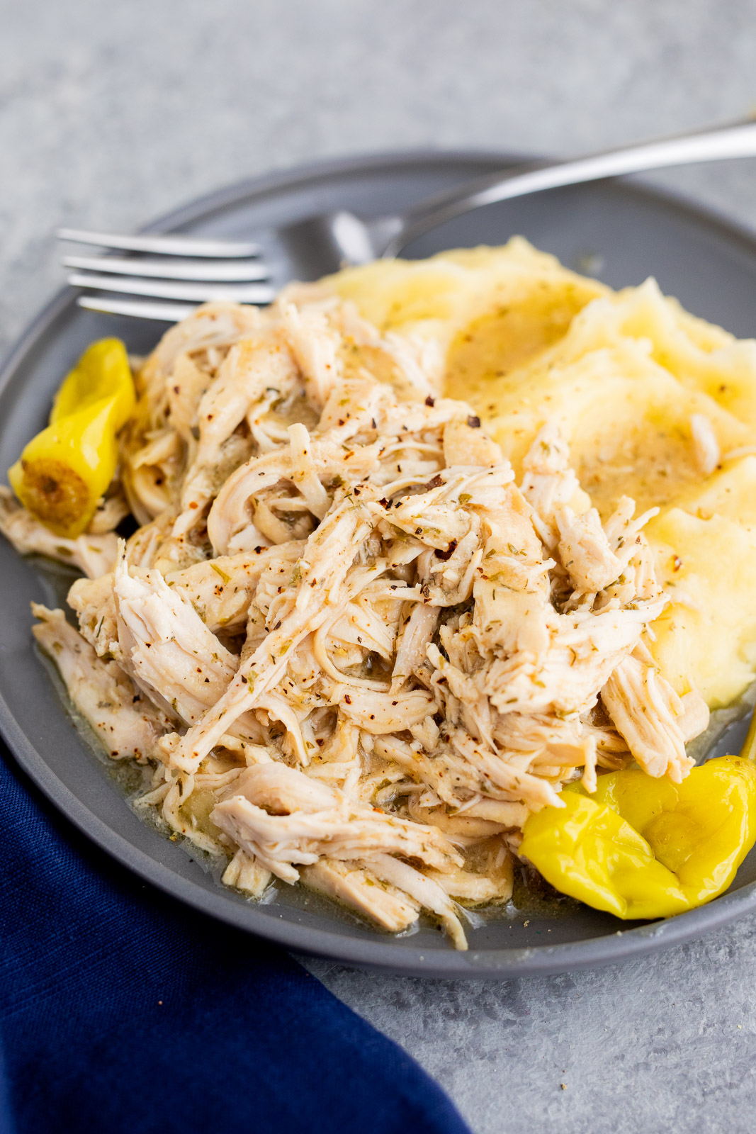 Mississippi chicken served over mashed potatoes