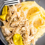 Slow Cooker Mississippi Chicken served over mashed potatoes