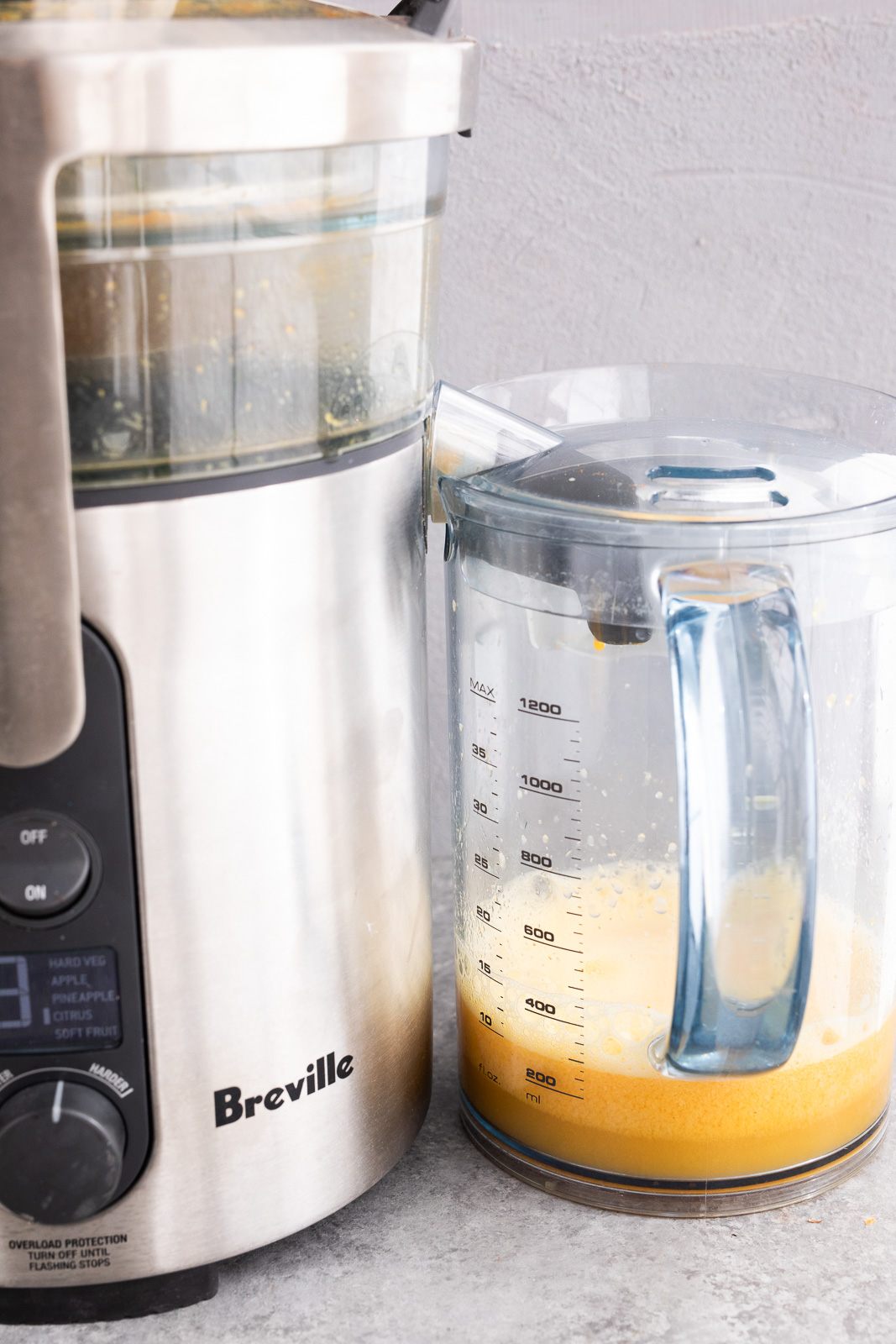 Juicing ginger, turmeric, orange, and lemon for homemade wellness shots
