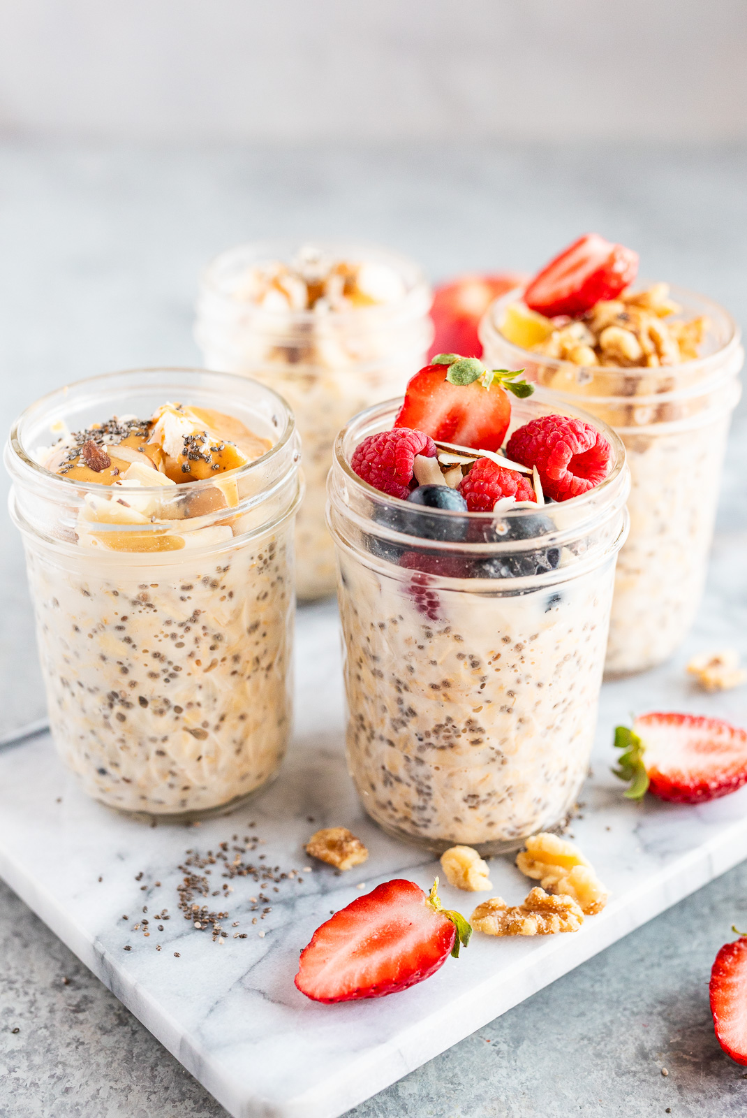easy overnight oats recipe in jars made with 3 main ingredients and topped with fruit and nuts