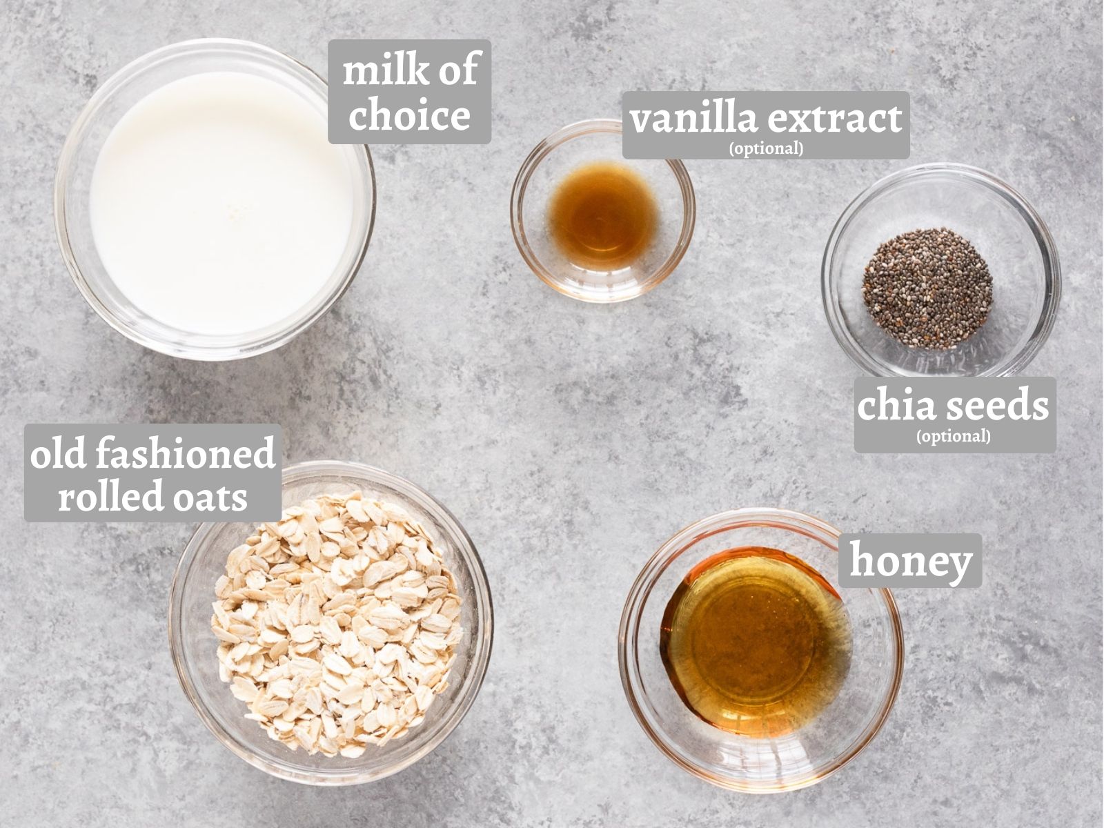 ingredients for making overnight oats with oats milk sweetener and optional vanilla extract and chia seeds